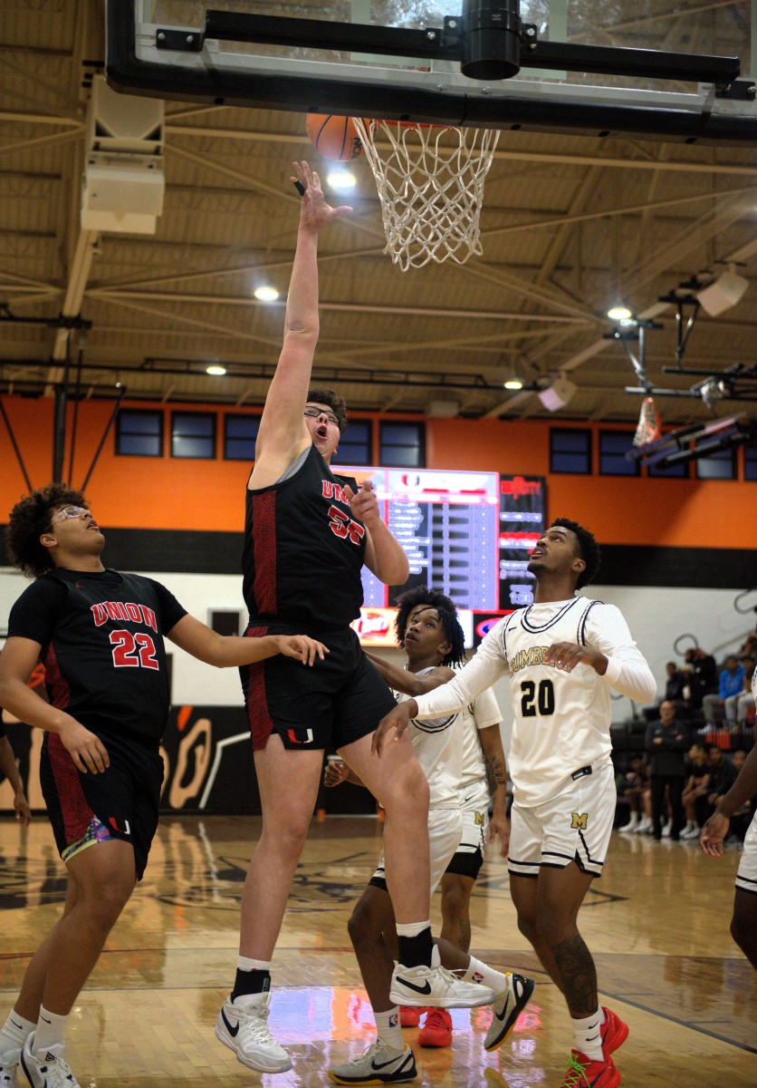 Tulsa Union 7-foot-2 center Erik Madrid goes in for a basket during a game at the recent Putnam City Invitational tournament.